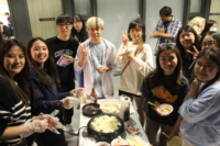 Students at Japanese Cultural Night enjoying delicious Takoyaki
